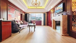 A spacious living room with a fireplace, a sofa, a coffee table, and a large window offering a city view. - Dilunting International Hotel (Wansheng Yaocheng) (Chongqing)