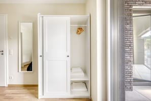 Enjoy a spacious room with ample storage, a brick accent wall, and a balcony access.