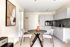 Prepare meals and socialize around the central island with a round table, featuring an oven and microwave.