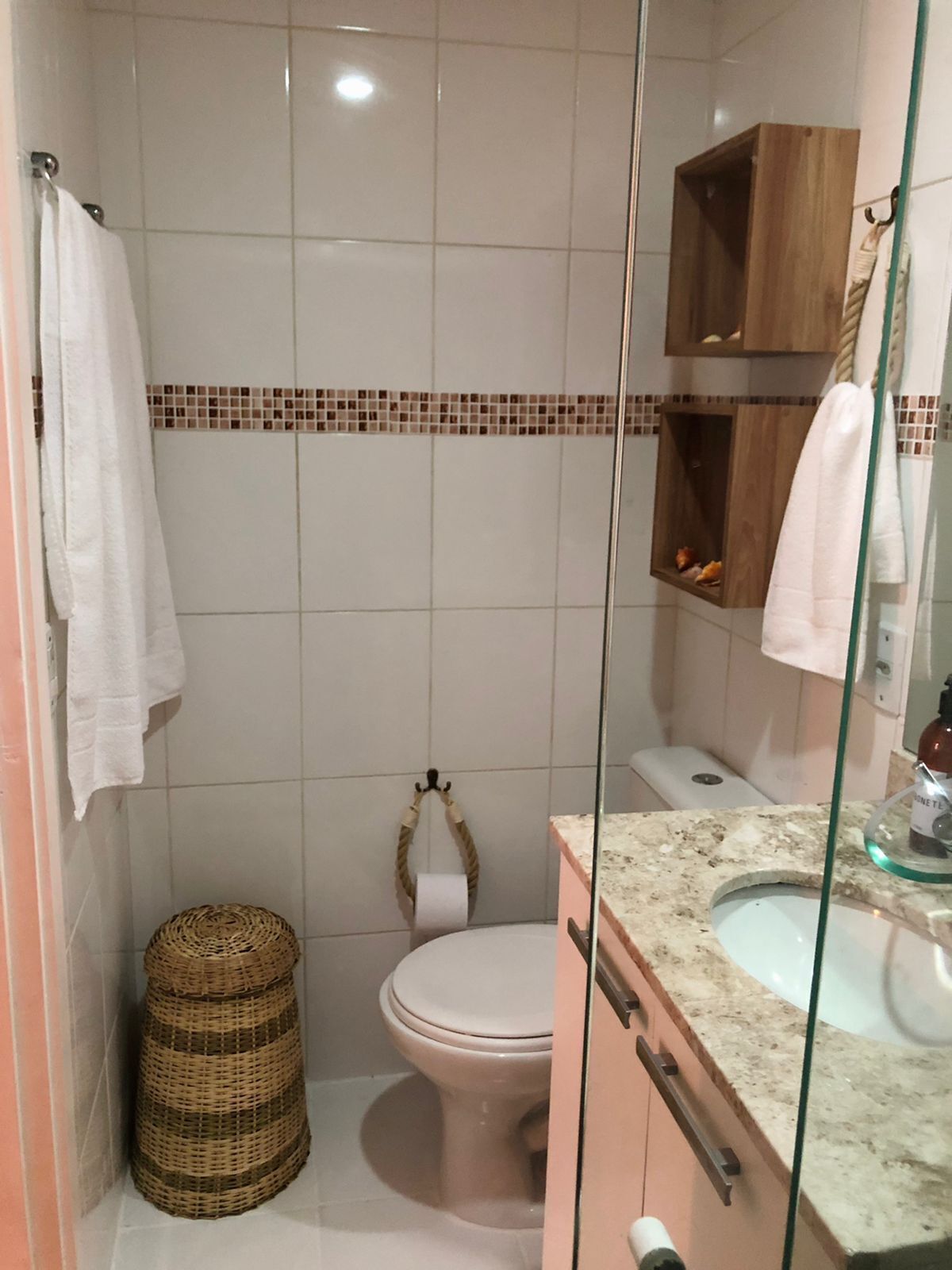 A bathroom with a toilet, a sink, and a shower area.