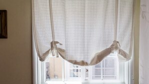 A window with a white curtain and a decorative rope. - 2 BD Quiet Neighborhood with AC, Desk, Fast Wifi (Torrance)