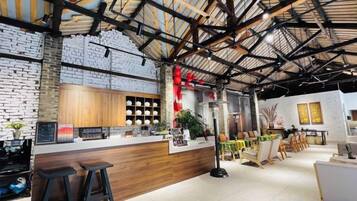 A modern interior with a bar area, wooden counter, and seating.