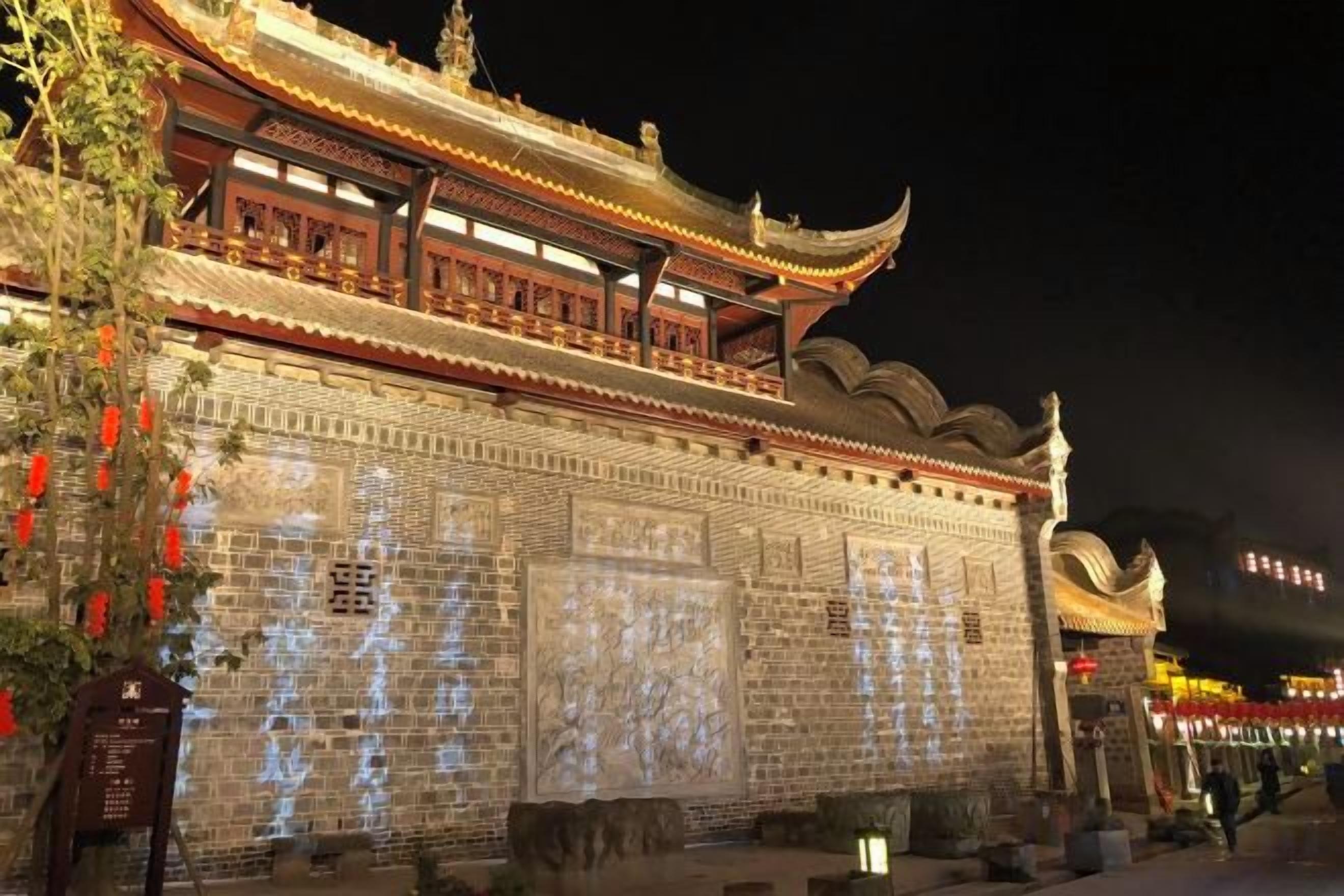 A traditional building with a tiled roof and a large entrance gate.