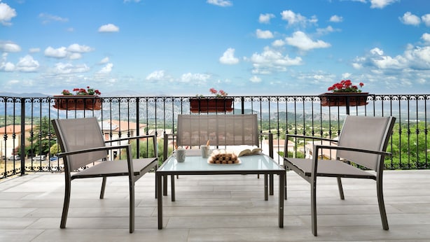 A balcony with a table and chairs, potted plants, and a view of the landscape. - Holiday Apartment 'Dolcecasa' with Mountain View, Private Terrace & Wi-Fi (Dorgali)