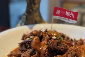 A dish with a flag indicating it is from a specific region. - Guoguang Hotel (Yizhang)