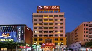 A multi-story hotel with a prominent sign at the top.