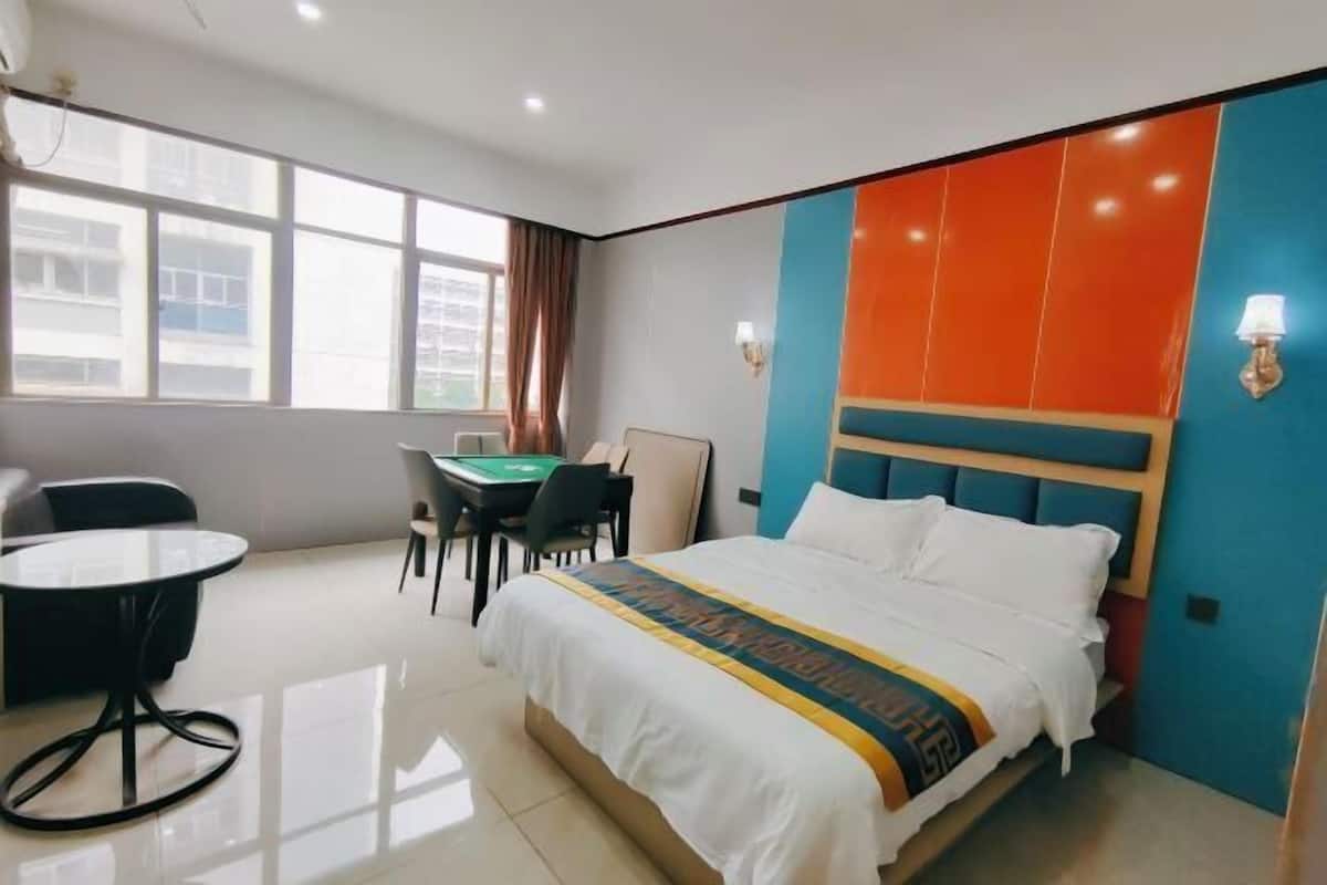 Une chambre d’hôtel avec un lit, un bureau et une chaise.