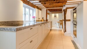A kitchen with white cabinets, granite countertops, and a wooden ceiling. - Landers, Cheltenham - sleeps 10 guests  in 5 bedrooms (Cheltenham)