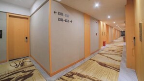 Un pasillo de hotel con señales direccionales que indican los números de habitación 8305 a 8307 y 8308 a 8335.