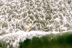 A person on a surfboard in the water.