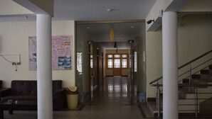 A spacious lobby with a central corridor, a staircase, and a sofa area. - Hotel Cedar Inn (Mansehra)