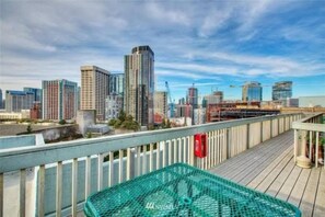 A city skyline with modern buildings, a wooden deck, and a green safety net.