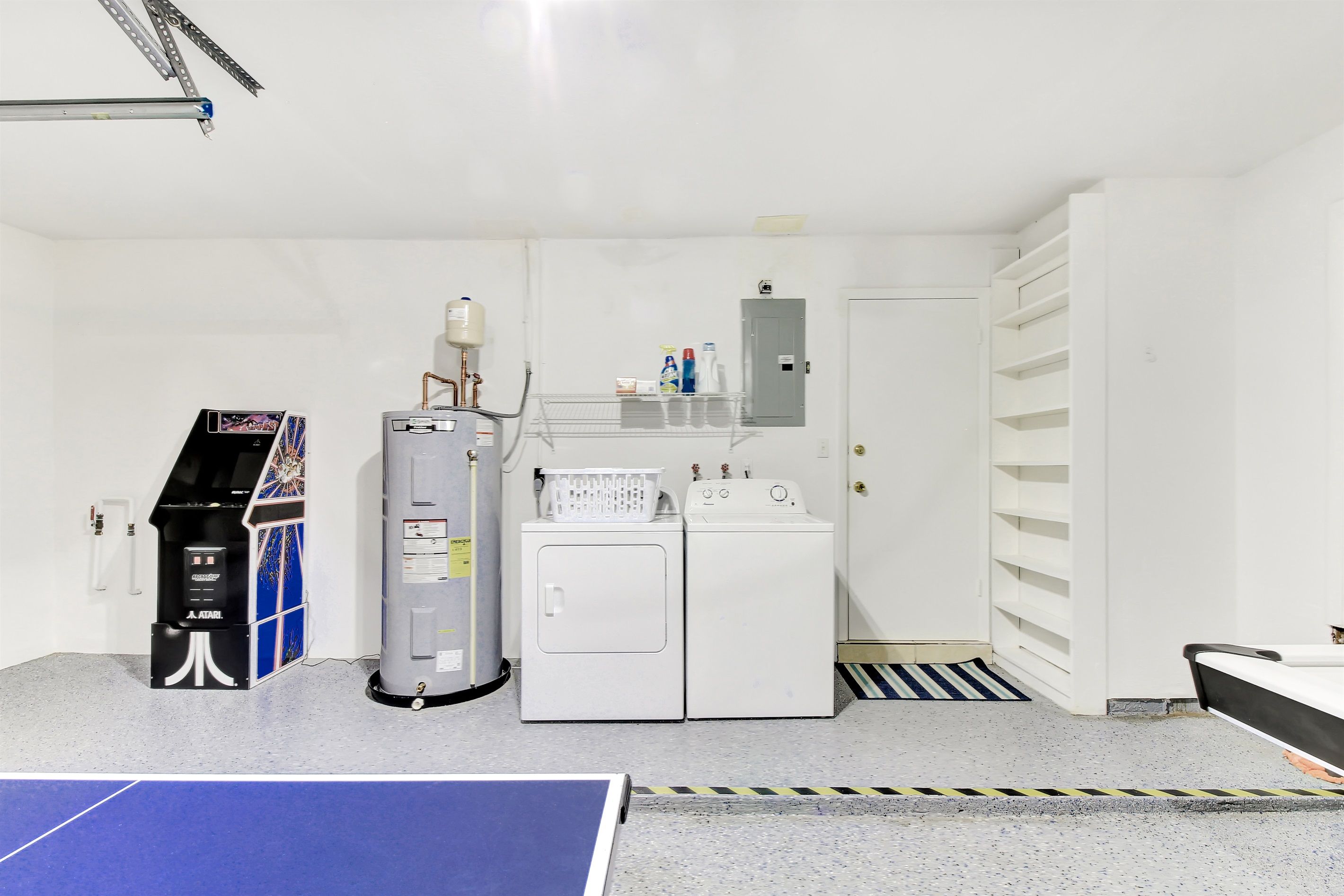 A laundry room with a washing machine, dryer, and a water heater.