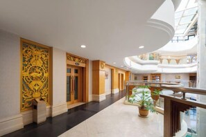 A spacious hotel lobby with a high ceiling, a central atrium, and a glass railing overlooking the lower level. - Xiang Wang Fu Hotel (Huaibei)