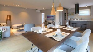 A modern living room with a dining area, a kitchen, and a TV in the background. - Villa Valle by Interhome (Rovinj/Bale)
