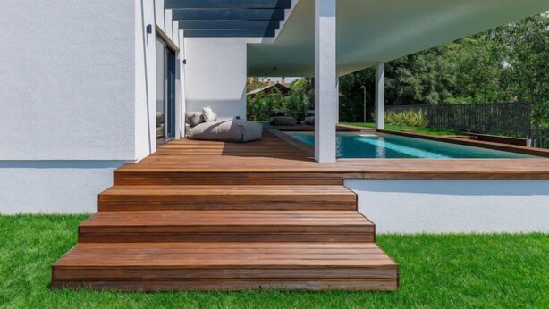 A modern outdoor pool area with a wooden deck leading to a seating area under a pergola. - Villa Valle by Interhome (Rovinj/Bale)