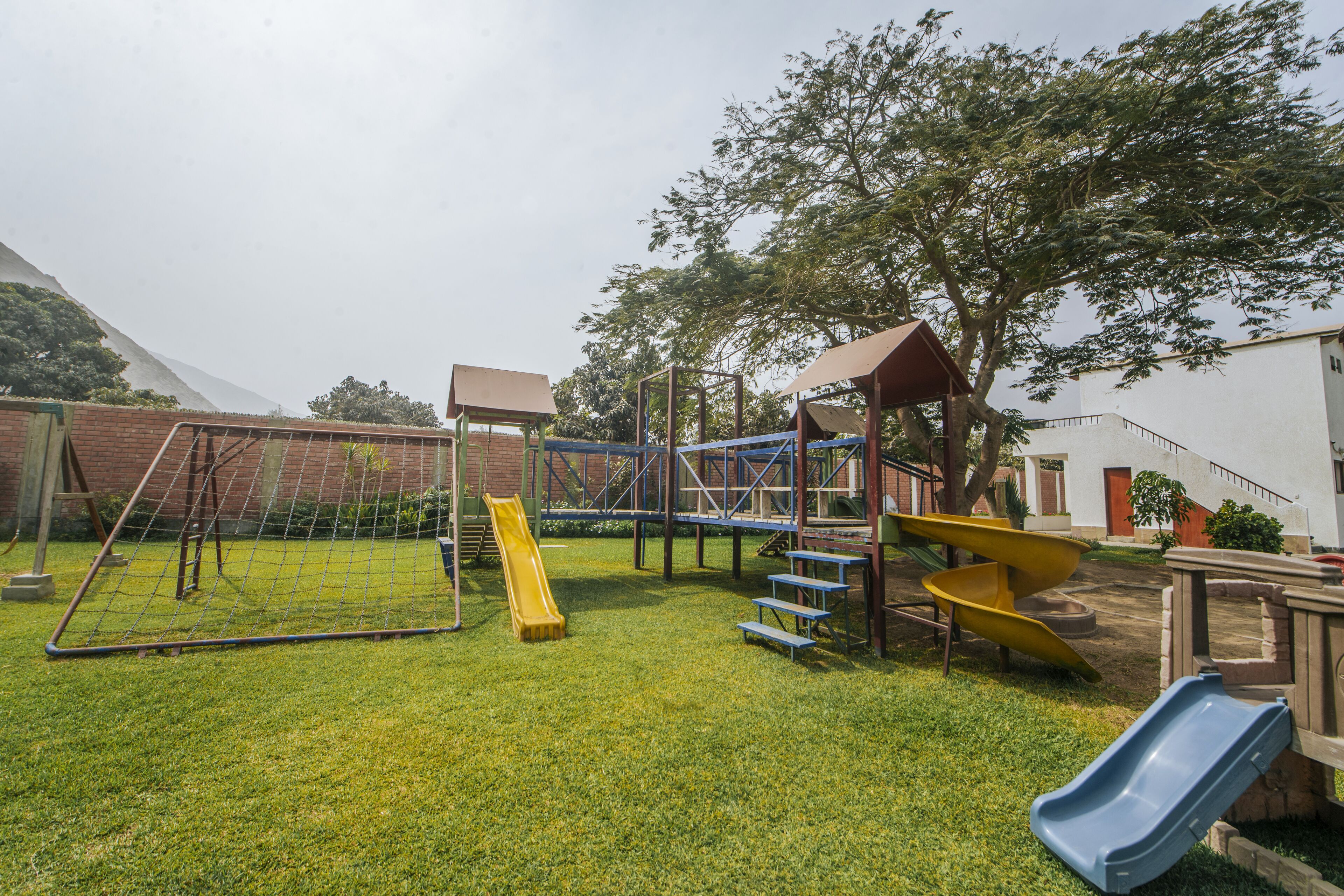 Ein Spielplatz mit Rutschen und Klettergerüsten.