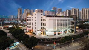 A modern hotel with a central courtyard, surrounded by high-rise buildings. - Sanfeng Hotel (Nanning)