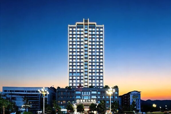 A high-rise hotel with multiple floors, a prominent entrance, and a clear view of the surrounding area.