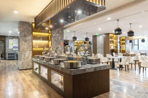 A modern hotel lobby with a marble reception desk, seating area, and contemporary lighting. - Chongqing Tongcheng Zhiguang Hotel (Tongnan Branch) (Chongqing)