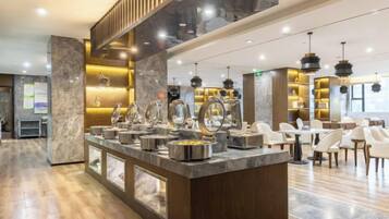 A modern hotel lobby with a marble reception desk, seating area, and contemporary lighting fixtures.