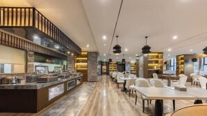 A modern restaurant with a long counter, seating area, and a kitchen visible in the background. - Chongqing Tongcheng Zhiguang Hotel (Tongnan Branch) (Chongqing)