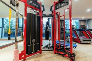 A gym with exercise equipment, treadmills, and a punching bag. - Chongqing Tongcheng Zhiguang Hotel (Tongnan Branch) (Chongqing)
