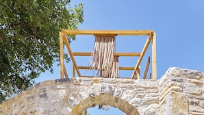 A stone staircase leading up to a wooden structure with a thatched roof. - Villa Fisi 1 - Pool, Hot Tub & Mountain View (Mylopotamos)