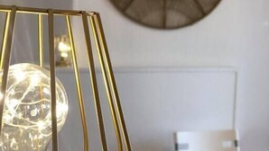 A modern room with a decorative light fixture, a round mirror on the wall, and a white chair. - "L'Historique": House 2 minutes' walk from the center (Bayeux)