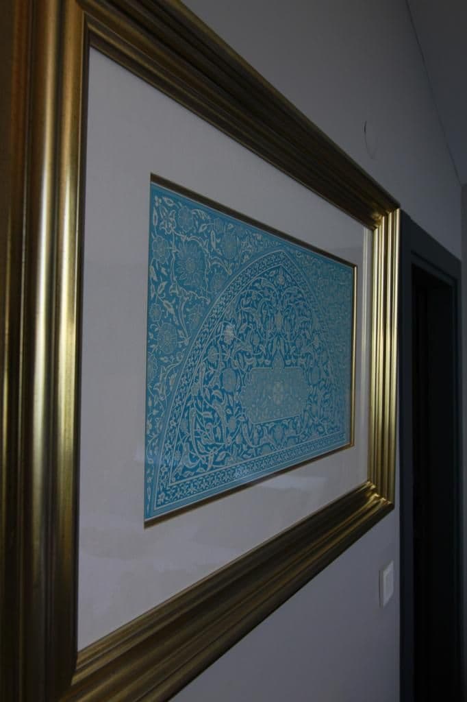 A framed artwork on a wall.