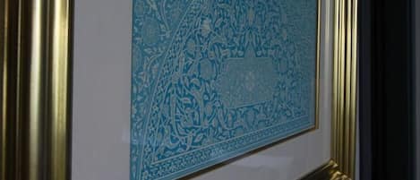 A framed artwork on a wall.