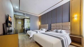 A hotel room with two beds, a TV, a wooden cabinet, and a wall-mounted light fixture. - Xinjia Fashion Hotel (Guangzhou Shigang East Village Store) (Guangzhou)