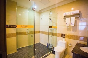 A hotel bathroom with a glass-enclosed shower, a toilet, and a sink. - A Fu Er Lian Suo Jiu Dian (Youyang County)