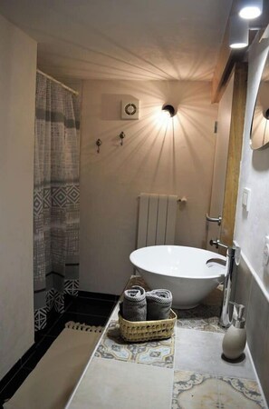 A bathroom with a freestanding bathtub, a towel rack, and a patterned floor. - Lovely detached cocoon in green property-terrace/garden (Barjols)