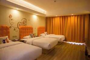 A hotel room with three beds, a large window with curtains, and a wall with a floral design. - Tao Flute Hotel (Guilin)