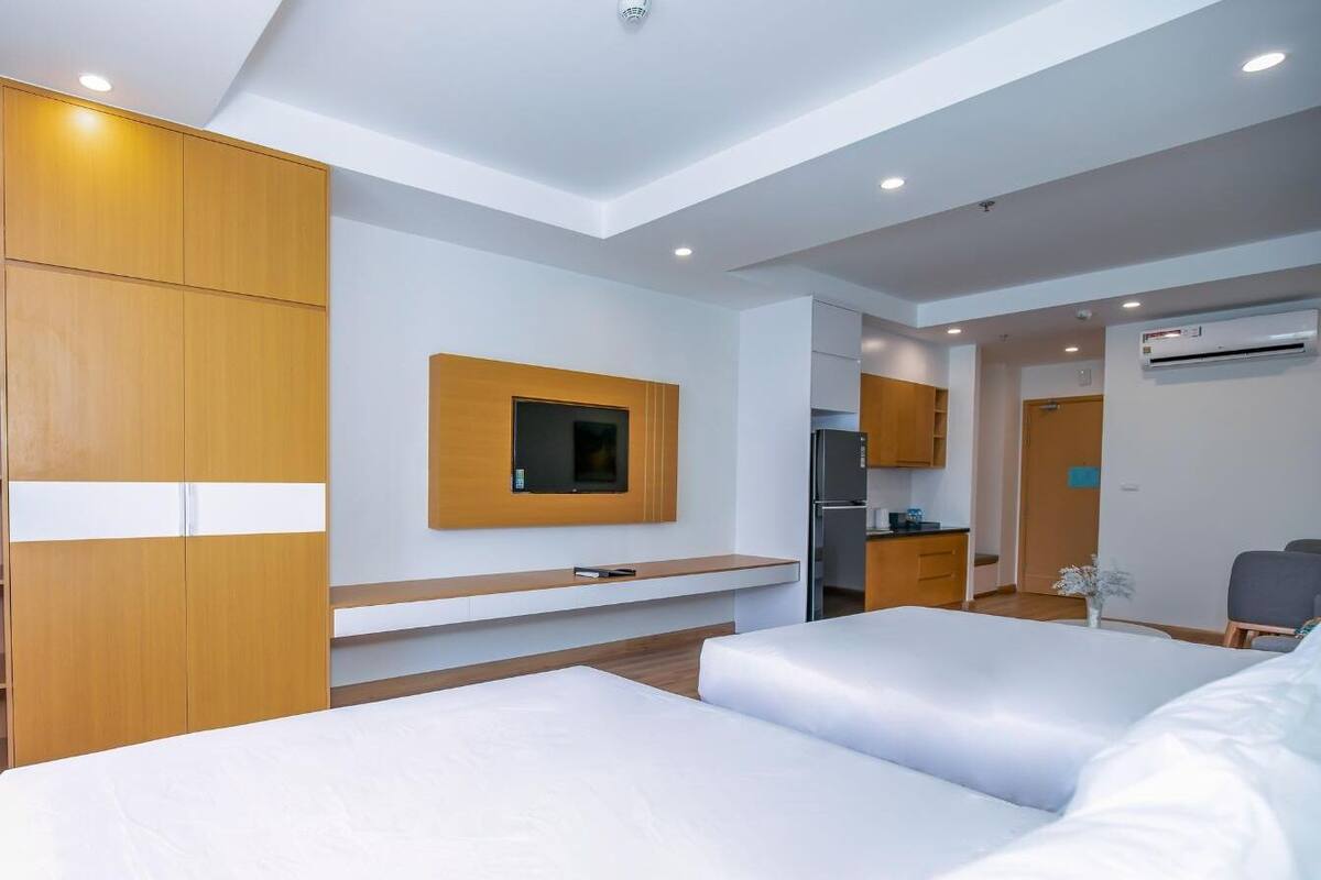Premium bedding, desk, laptop workspace, blackout drapes