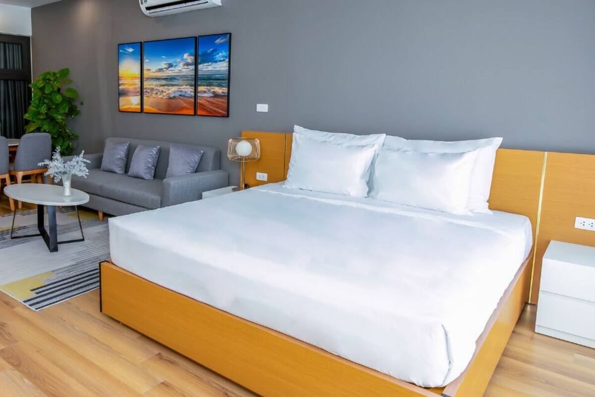 Premium bedding, desk, laptop workspace, blackout drapes