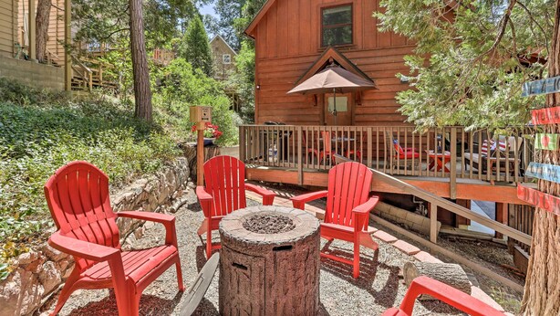 A wooden cabin with a deck, surrounded by trees and a fire pit. - Steps to Lake: Cabin w/ Deck in Lake Arrowhead (Lake Arrowhead)