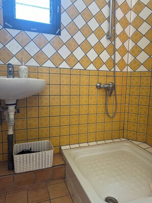 A bathroom with a bathtub, a sink, and a shower.