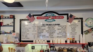 A menu board at a shop named 'King's Homemade Ice Cream Shop' with various ice cream flavors and prices listed.
