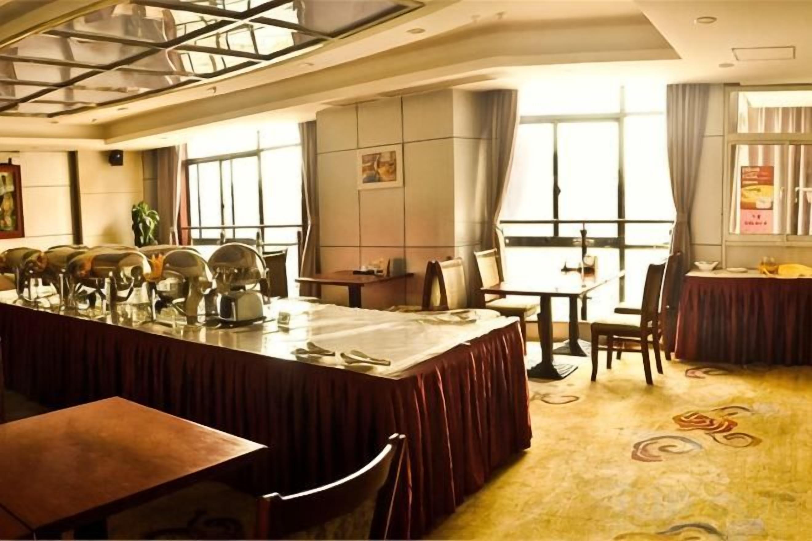 A conference room with a long table, chairs, and a large window.