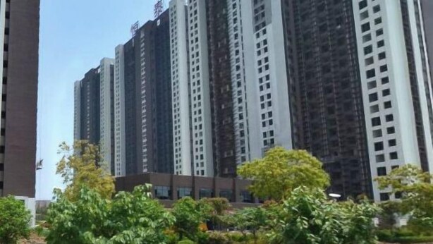 A high-rise residential building with multiple floors, surrounded by greenery and trees. - Wenhai Hotel (Ma'anshan)