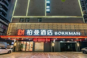 Welcome to Borreman, featuring a modern design with a unique patterned facade and a contemporary glass entrance.