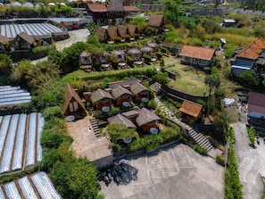 A resort with thatched-roof cottages, a central courtyard, and a parking area. - Segara Camp Kintamani (Kintamani)