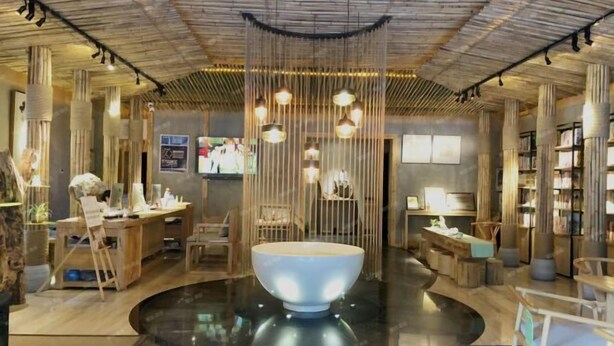 A modern interior with a central reflective water feature, wooden furniture, and a bookshelf. - NengHui Star Hotel (Guiyang)