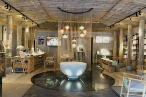A modern interior with a central seating area, wooden furniture, and pendant lighting. - NengHui Star Hotel (Guiyang)