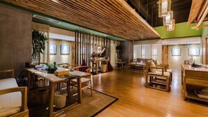 A spacious hotel lobby with wooden flooring, multiple seating areas, and a high ceiling with exposed beams. - NengHui Star Hotel (Guiyang)