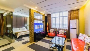 A hotel room with a bed, a TV, a sofa, and a coffee table. - Yasidun Hotel (Hohhot Convention and Exhibition Center) (Hohhot)