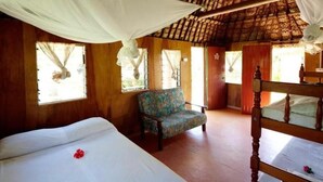 A room with a bed, a chair, and a wooden headboard. - Nabua Lodge Hidden Getaway (Nacula Island)