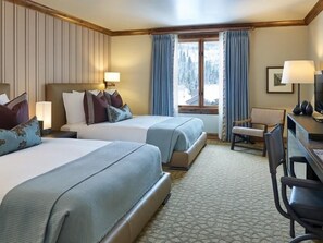 A hotel room with two beds, a desk, a chair, a TV, and a window with curtains. - Two Bedroom Residential Suite at The Sebastian Vail (Vail)